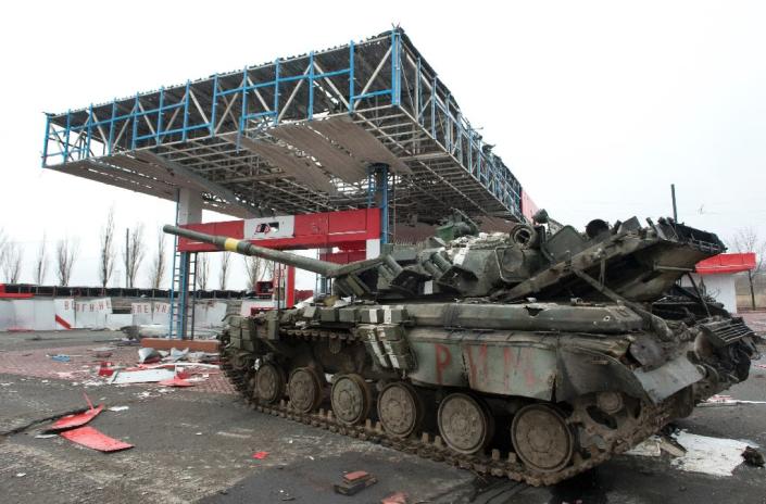 A damaged Ukrainian army tank is immobilised in a wrecked petrol station outside the eastern city of Debaltseve, on February 28, 2015 (AFP Photo/John Macdougall)
