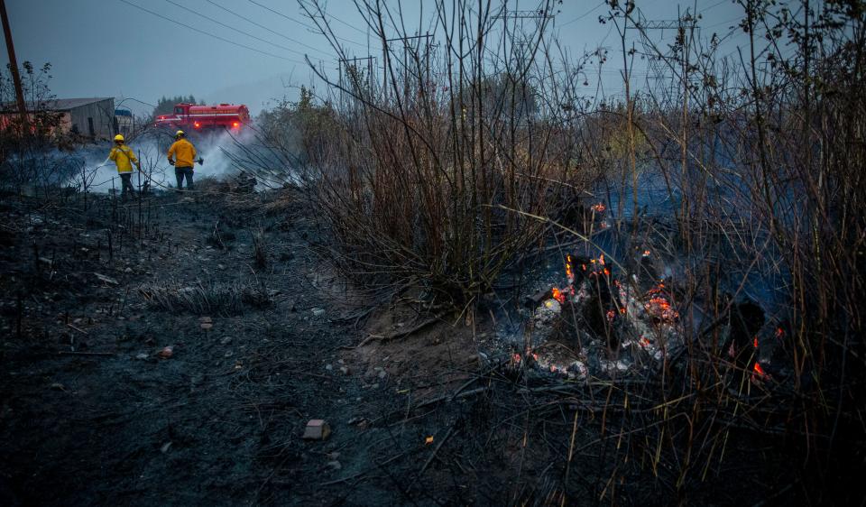 Goshen Fire District firefighters work to put out a grass fire off of Seavey Loop road on Sept. 23, 2020, near Goshen, Oregon.