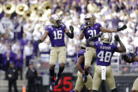 Washington's Cameron Williams (16) celebrates his interception against Southern Cal with teammate Kamren Fabiculanan (31) in the first half of an NCAA college football game Saturday, Sept. 28, 2019, in Seattle. (AP Photo/Elaine Thompson)