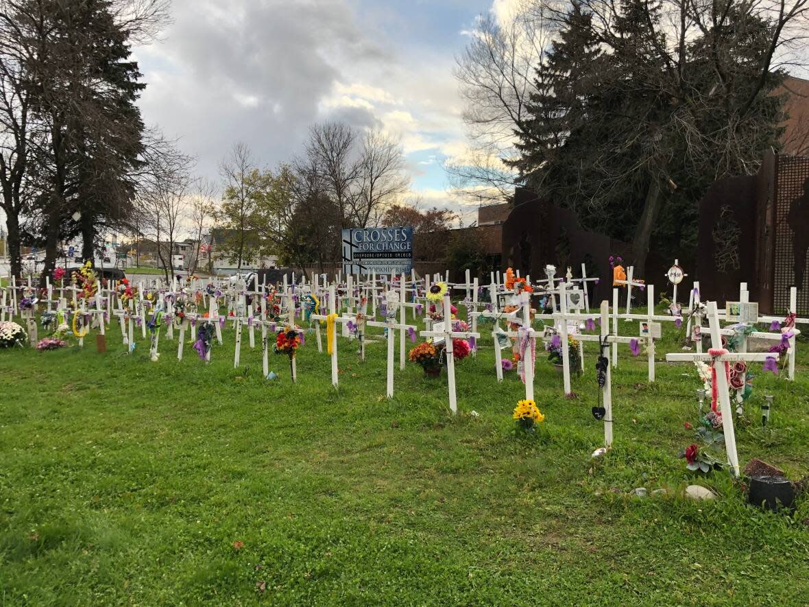 Over 200 white crosses line the Crosses for Change site on the corner of a busy intersection in downtown Sudbury. It's a poignant and eye-catching memorial to those individuals lost to the opioid crisis. (Angela Gemmill/CBC - image credit)