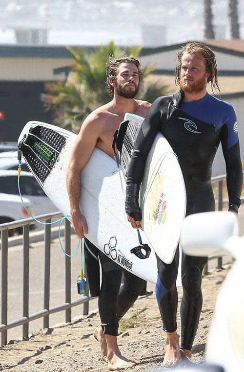 Liam Hemsworth bares all before a day in the surf