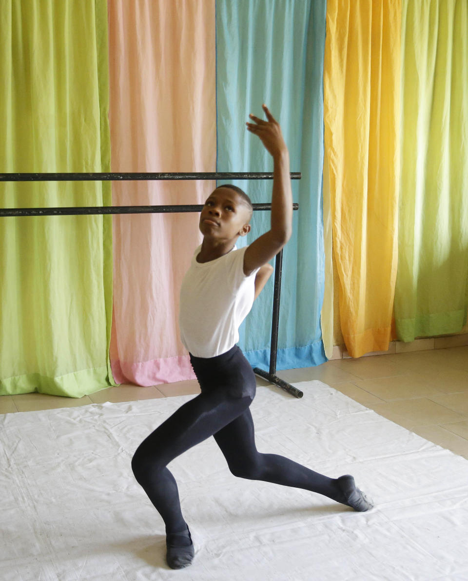 Ballet dancer Anthony Mmesoma Madu rehearses in Lagos, Nigeria on Aug. 18, 2020. Cellphone video showing the 11-year-old dancing barefoot in the rain went viral on social media. Madu’s practice dance session was so impressive that it earned him a ballet scholarship with the American Ballet Theater in the U.S. (AP Photo/Sunday Alamba)