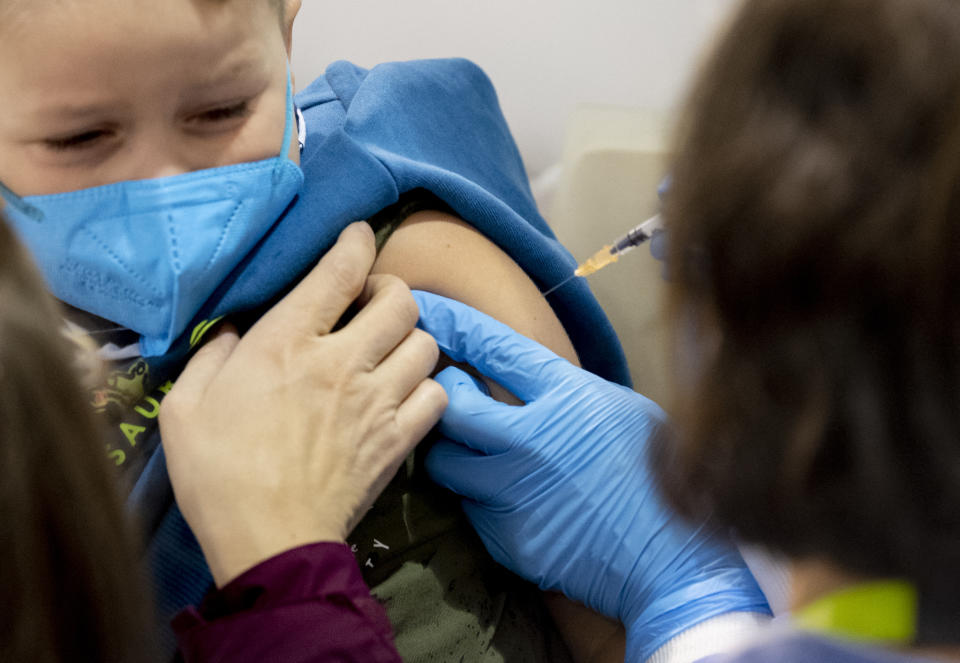 A five year old boy receives his first shot of the corona vaccine in Vienna, Austria on November 15, 2021.