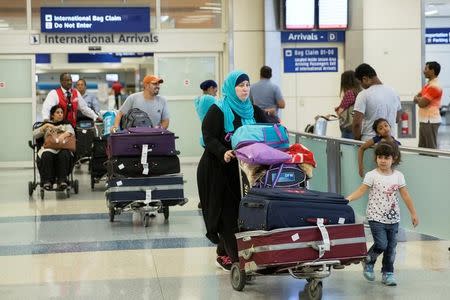 People come through the International Arrivals gate from Dubai at Dallas/Fort Worth International Airport in Texas, U.S., June 29, 2017. REUTERS/Laura Buckman/Files