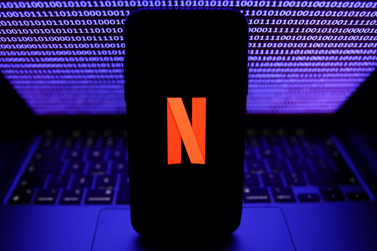 A binardy code displayed on a laptop screen and Netflix logo displayed on a phone screen are seen in this illustration photo taken in Krakow, Poland on October 30, 2023. (Photo by Jakub Porzycki/NurPhoto via Getty Images)