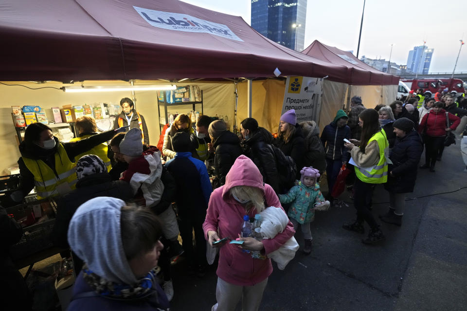 Ukrainian refugees pick up donated food and hygiene and bayby care products at the Warsaw Centralna train station, in Poland, Wednesday, March 16, 2022. Overall, more than 3 million refugees have fled Ukraine, the U.N. said, Europe's largest refugee crisis since WWII. (AP Photo/Czarek Sokolowski)