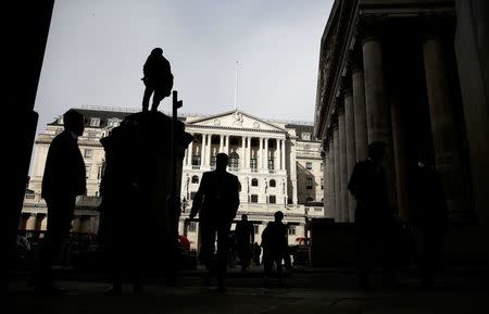 FILE PHOTO - Pedestrians are silhouetted as the winter sun shines on to front of the Bank of England in the City of London, Britain, November 3, 2016. REUTERS/Peter Nicholls/File Photo