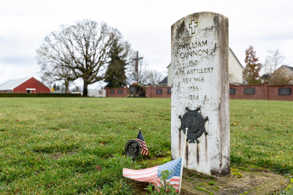 A marble headstone honors William Cannon, the only documented Revolutionary War soldier buried in Oregon, at St. Paul Pioneer Cemetery in St. Paul.