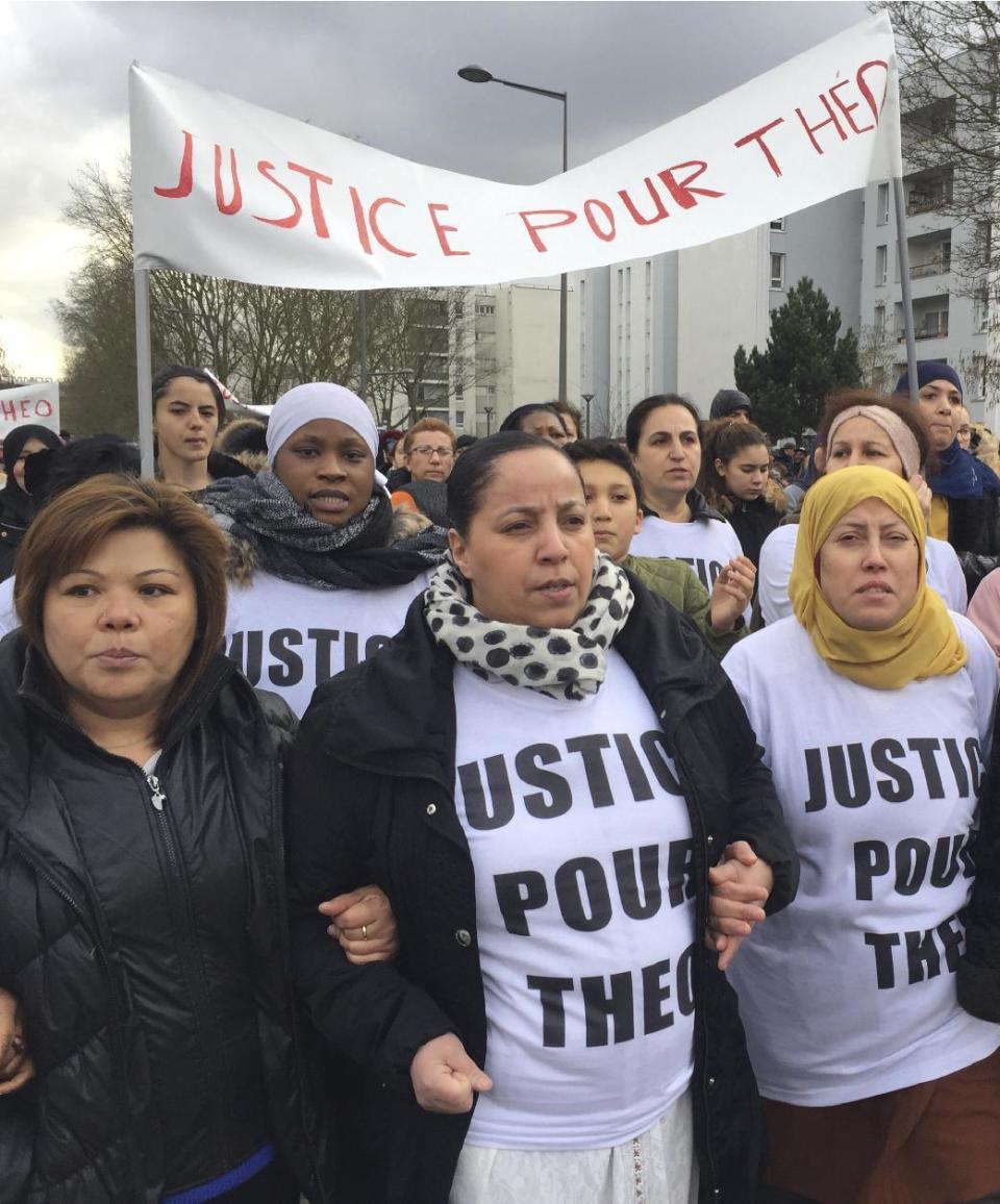 People march in the streets of Aulnay-sous-Bois, north of Paris, France, holding a sign reading "Justice for Theo" during a protest, a day after a French police officer was charged with the rape of a youth, Monday, Feb. 6, 2017. One French police officer has been charged with raping a 22-year-old man and three others have been charged with assault after an identity check degenerated last week in the Paris suburb of Aulnay-sous-Bois. (AP Photo/Milos Krivokapic)