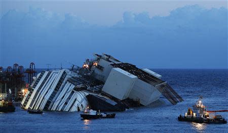 The capsized cruise liner Costa Concordia lies on its side next to Giglio Island September 16, 2013. REUTERS/Tony Gentile