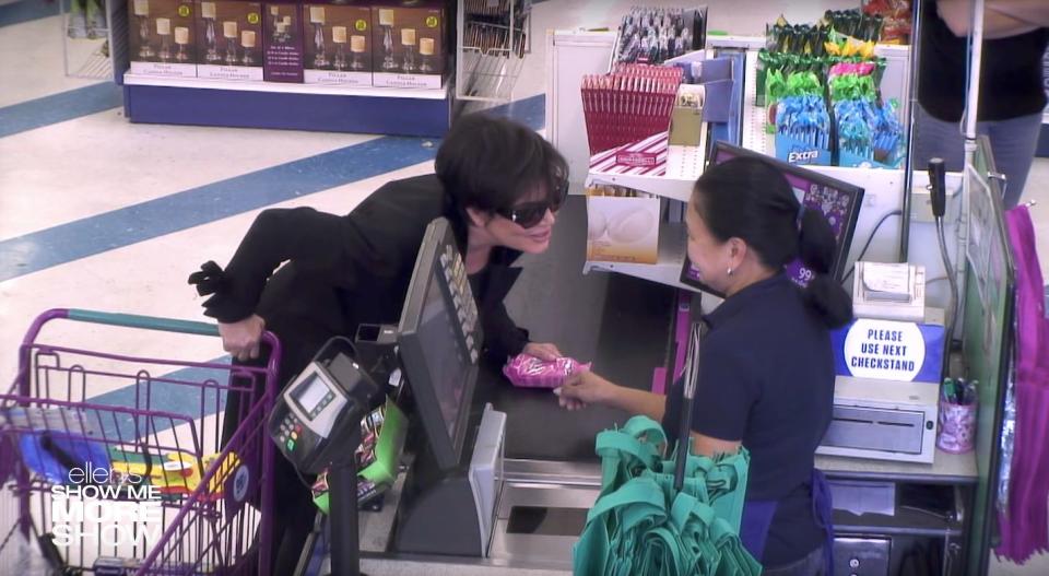 Kris Jenner leans in to whisper a secret to the cashier about a pack of razors. (Photo: The Ellen Show)