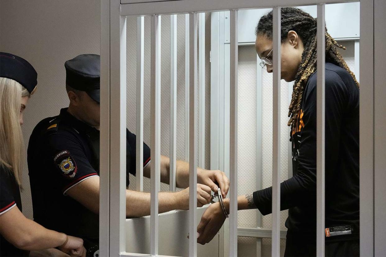 Policeman removes the handcuffs from WNBA star and two-time Olympic gold medalist Brittney Griner in a courtroom prior to a hearing, in Khimki just outside Moscow, Russia, . American basketball star Brittney Griner returned Wednesday to a Russian courtroom for her drawn-out trial on drug charges that could bring her 10 years in prison of convicted Russia Griner, Moscow, Russian Federation - 27 Jul 2022