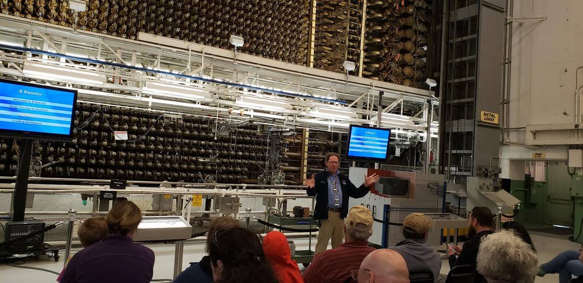 A tour guide speaks to visitors at the front face of Hanford’s B Reactor at the Manhattan Project National Historical Park.