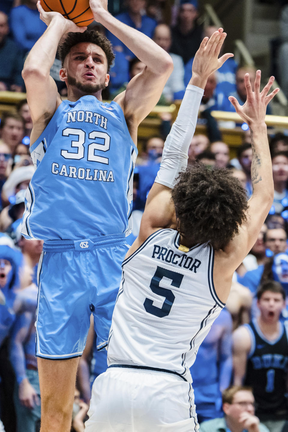 North Carolina forward Pete Nance (32) looks to shoot while guarded by Duke guard Tyrese Proctor (5) in the first half of an NCAA college basketball game on Saturday, Feb. 4, 2023, in Durham, N.C. (AP Photo/Jacob Kupferman)