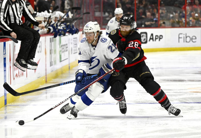 Ottawa Senators right wing Claude Giroux (28) gets his stick in front of Tampa Bay Lightning center Brayden Point (21) to take the puck from him during first-period NHL hockey game action in Ottawa, Thursday, March 23, 2023. (Justin Tang/The Canadian Press via AP)