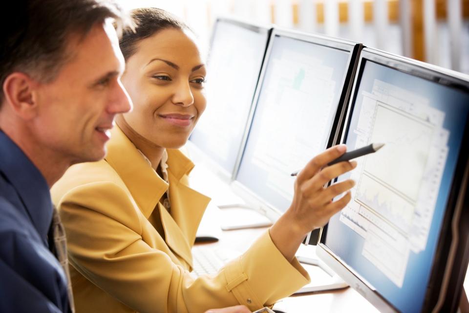 Two people looking at a computer screen.