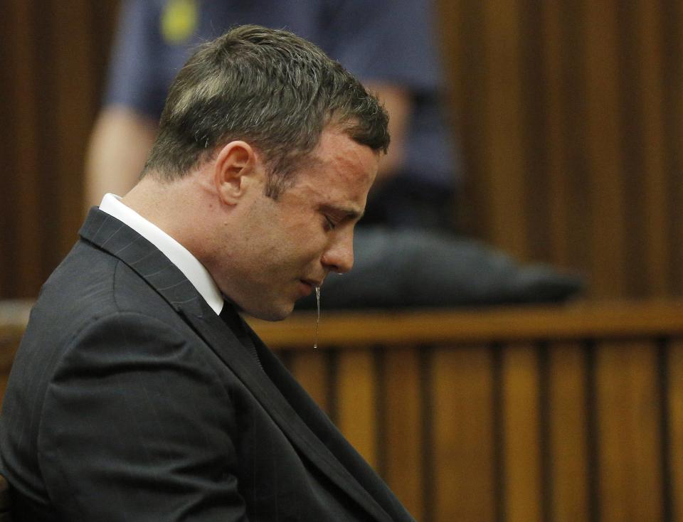 Olympic and Paralympic track star Oscar Pistorius reacts as he listens to Judge Thokozile Masipa's judgement at the North Gauteng High Court in Pretoria, September 11, 2014. A South African judge cleared Oscar Pistorius of all murder charges on Thursday, saying prosecutors had failed to prove the Olympic and Paralympic track star intended to kill his girlfriend or an imagined intruder on Valentine's Day last year. REUTERS/Kim Ludbrook/Pool (SOUTH AFRICA - Tags: SPORT ATHLETICS ENTERTAINMENT CRIME LAW SOCIETY)