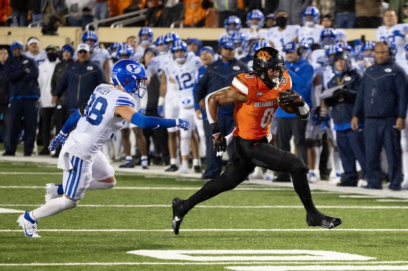 Oklahoma State running back Ollie Gordon II (0) runs past BYU safety Crew Wakley (38) for a touchdown in the second half of an NCAA college football game Saturday, Nov. 25, 2023, in Stillwater, Okla. | Mitch Alcala