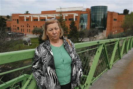 Carmen Collado poses for a picture in front of her working place outside Madrid March 14, 2014. Collado has laundered hospital linen for 11 years. REUTERS/Andrea Comas