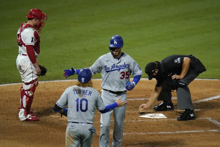 Los Angeles Dodgers' Cody Bellinger (35) celebrates his two-run home run with Justin Turner during the sixth inning.