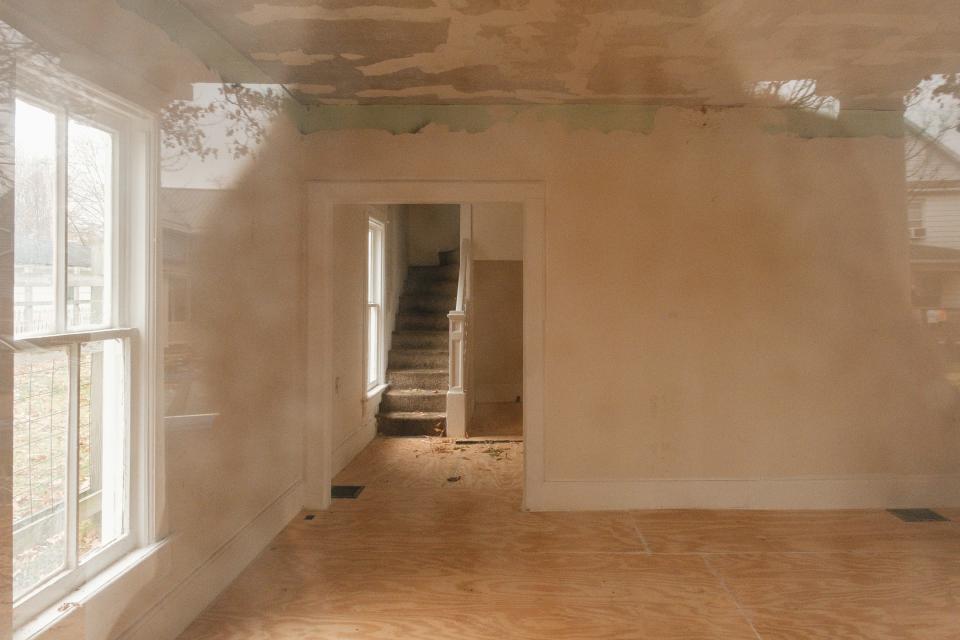 The interior of a condemned home at 232 Third Street SW in New Philadelphia can be seen through the front door on Monday. An ordinance being considered by New Philadelphia City Council would require property owners to register buildings within 90 days after they become vacant.