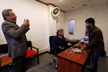 Journalist and columnists (L-R) Abdul Qayyum Siddiqui, Matiullah Jan, and Basit Subhani, gesture as they record, what they say is a satire video clip, to upload on social media sites, in Islamabad, Pakistan March 14, 2019. Picture taken March 14, 2019. REUTERS/Akhtar Soomro