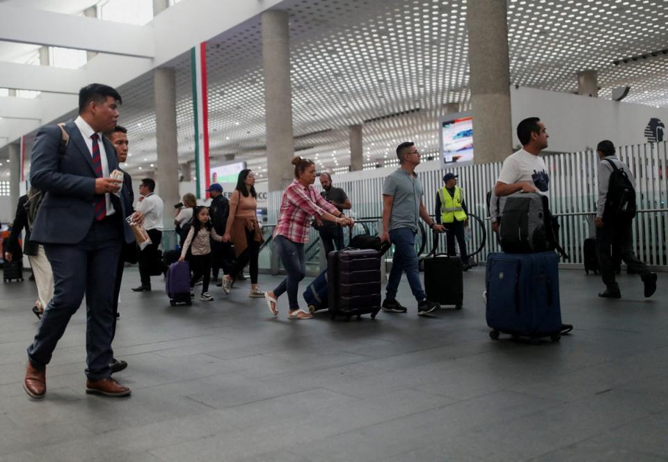 Passengers walk at Benito Juarez International airport in Mexico City (REUTERS)