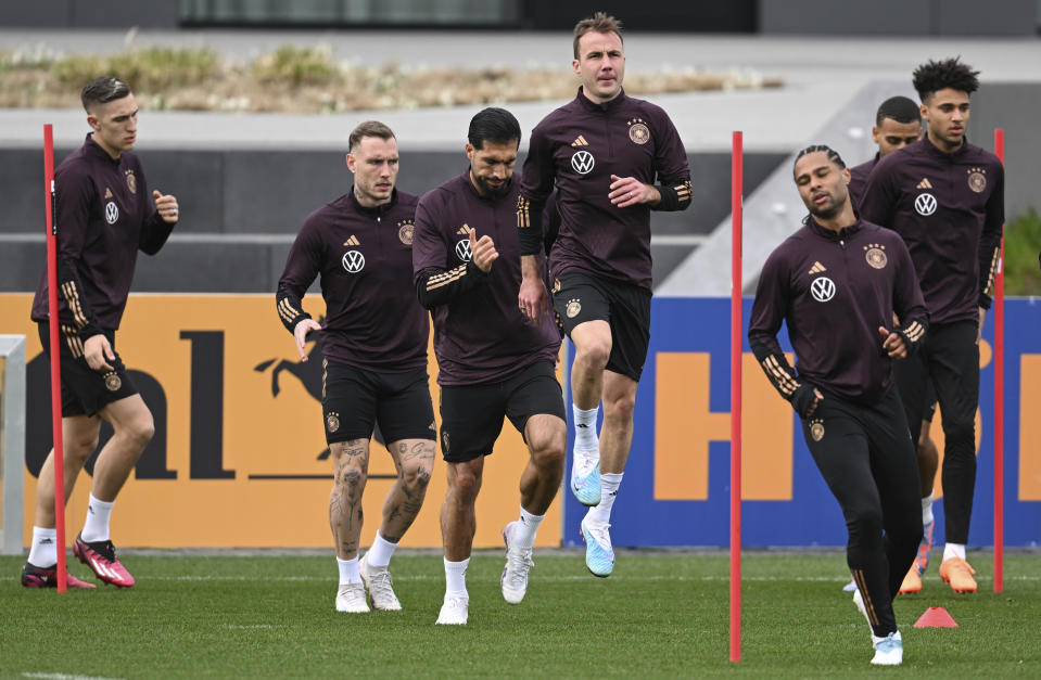 From left, Germany's Nico Schlotterbeck, David Raum, Emre Can, Mario Goetze, Serge Gnabry and Kevin Schade perform coordination exercises during the national team's training session at the DFB campus prior to the international match between Germany and Peru, in Frankfurt, Germany, Wednesday March 22, 2023. (Arne Dedert/dpa via AP)