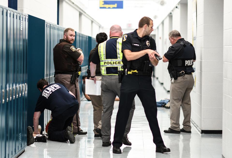 First responders and school officials during an active shooter training exercise on Wednesday, Aug. 17, 2022, at Grand Ledge High School. Students and teachers volunteered to act as victims with fake wounds and blood from the staged mock mass shooting.