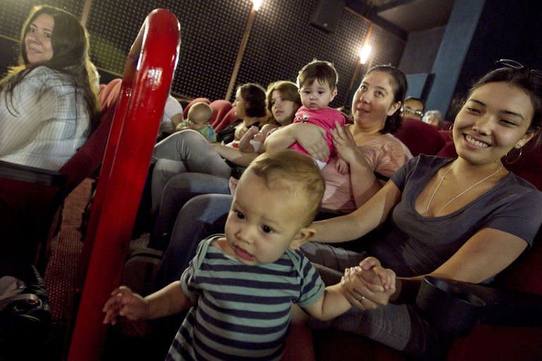 Mothers with their toddlers await for the start of the projection at a movie theatre as part of the CineMaterna program, in Sao Paulo, Brazil, in April 2011. CineMaterna is an NGO that promotes the return of mothers of up to eighteen-month-old babies to the cultural life by offering them specially suited movie sessions