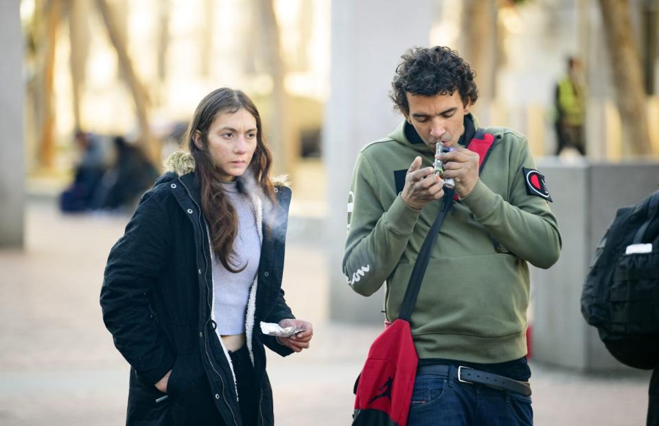 Drug users smoke at UN Plaza in San Francisco.