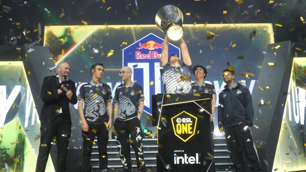Dota 2 team OG's carry player bzm lifts the trophy for ESL One Malaysia 2022.
