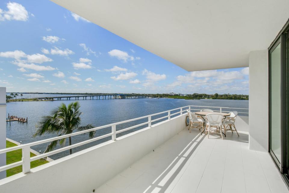 The lakefront balcony wraps around the south and west sides of the condominium and affords a view of the the bridge from South Ocean Boulevard to Lake Worth Beach.