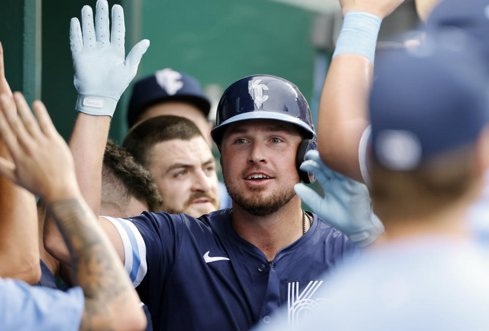 Kansas City Royals' Hunter Renfroe is congratulated in the dugout after his home run against the Cleveland Guardians during the second inning of a baseball game in Kansas City, Mo., Friday, June 28, 2024. (AP Photo/Colin E. Braley)