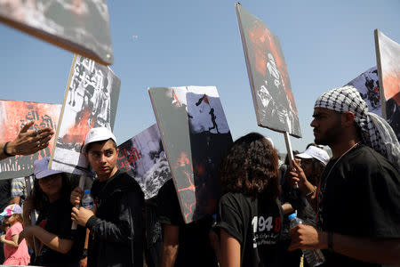 Israeli Arabs take part in a rally calling for the right of return for refugees who fled their homes during the 1948 Arab-Israeli War, near Atlit, Israel April 19, 2018. REUTERS/Ammar Awad