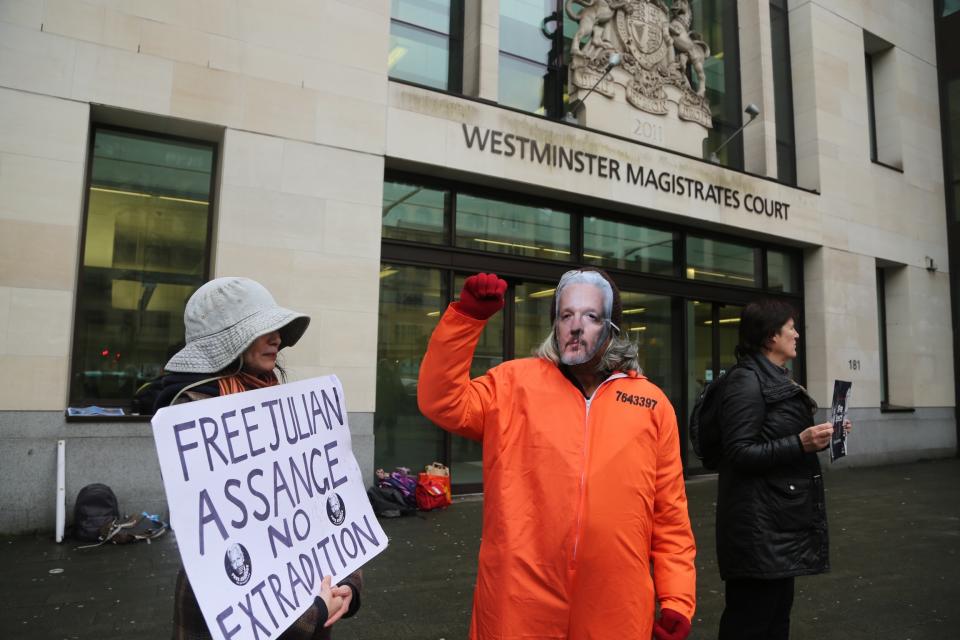 A demonstrator wearing a Julian Assange mask in London. (Ilyas Tayfun Salci/Anadolu Agency via Getty Images)