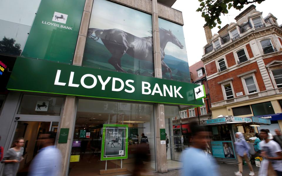 People walk past a branch of Lloyds Bank on Oxford Street - Peter Nicholls / Reuters