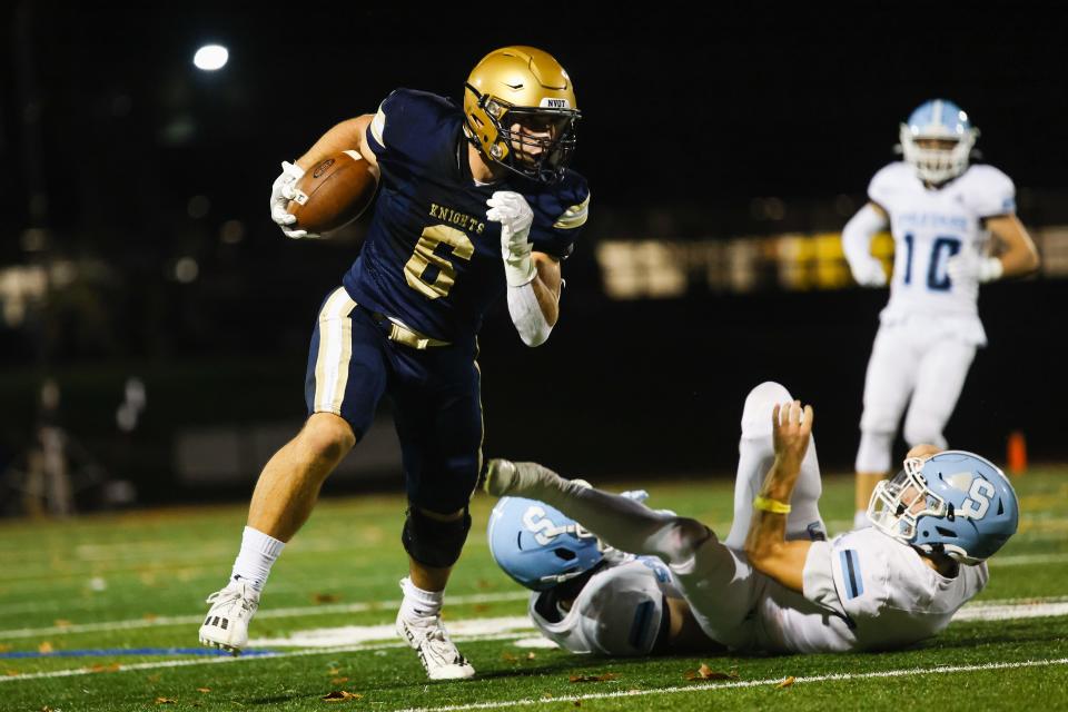 Old Tappan running back Aidan Heaney breaks a tackle on his way to a large downfield gain.