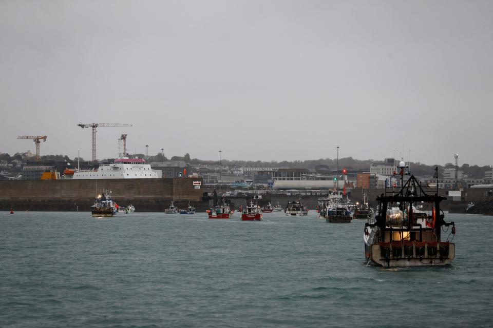 French fishing boats protest in front of the port of Saint Helier off the British island of Jersey to draw attention to what they see as unfair restrictions on their ability to fish in UK waters after Brexit, on May 6, 2021. - Around 50 French fishing boats gathered to protest at the main port of the UK island of Jersey on May 6, 2021, amid fresh tensions between France and Britain over fishing. The boats massed in front of the port of Saint Helier to draw attention to what they see as unfair restrictions on their ability to fish in UK waters after Brexit, an AFP photographer at the scene said. (Photo by Sameer Al-DOUMY / AFP) (Photo by SAMEER AL-DOUMY/AFP via Getty Images)