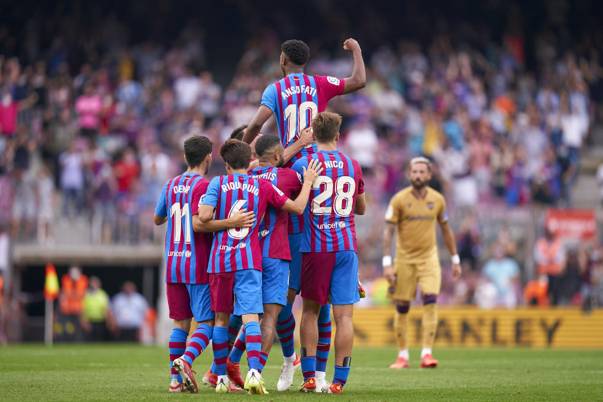 BARCELONA, SPAIN - SEPTEMBER 26: Ansu Fati of FC Barcelona celebrates with team mates after scoring his team's third goal during the LaLiga Santander match between FC Barcelona and Levante UD at Camp Nou on September 26, 2021 in Barcelona, Spain. (Photo by Pedro Salado/Quality Sport Images/Getty Images)