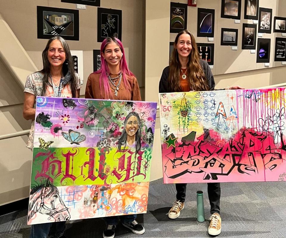 Avery Rodriguez, center, poses with custom art pieces she made for Silverado High School teachers Michelle Blum, left, and Shelly Sears, right, before graduating from Silverado earlier this year. The teachers coached Rodriguez as she created a portfolio that earned a perfect score on the AP Drawing Exam.