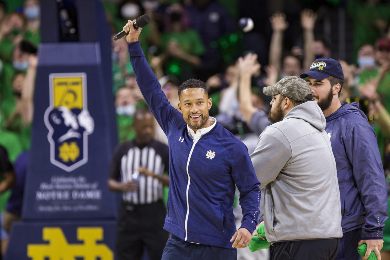 New Notre Dame head football coach Marcus Freeman is recognized on the court during a timeout during an NCAA college basketball game on Saturday, Dec. 11, 2021, in South Bend, Ind. (AP Photo/Robert Franklin)