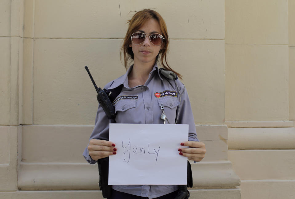 In this Feb. 19, 2014 photo, Cuban police officer Yenly Quintero poses in Old Havana, Cuba. Quintero is part of Cuba’s so-called Generation Y, the thousands upon thousands of islanders born during the Cold War whose parents turned tradition on its ear by giving them invented monikers inspired by Russian names like Yevgeny, Yuri or Yulia. More than two decades after the fall of the Iron Curtain, Cubans are increasingly returning to more traditional handles for their kids, saying they believe it will better suit them personally and professionally when they grow up. (AP Photo/Franklin Reyes)
