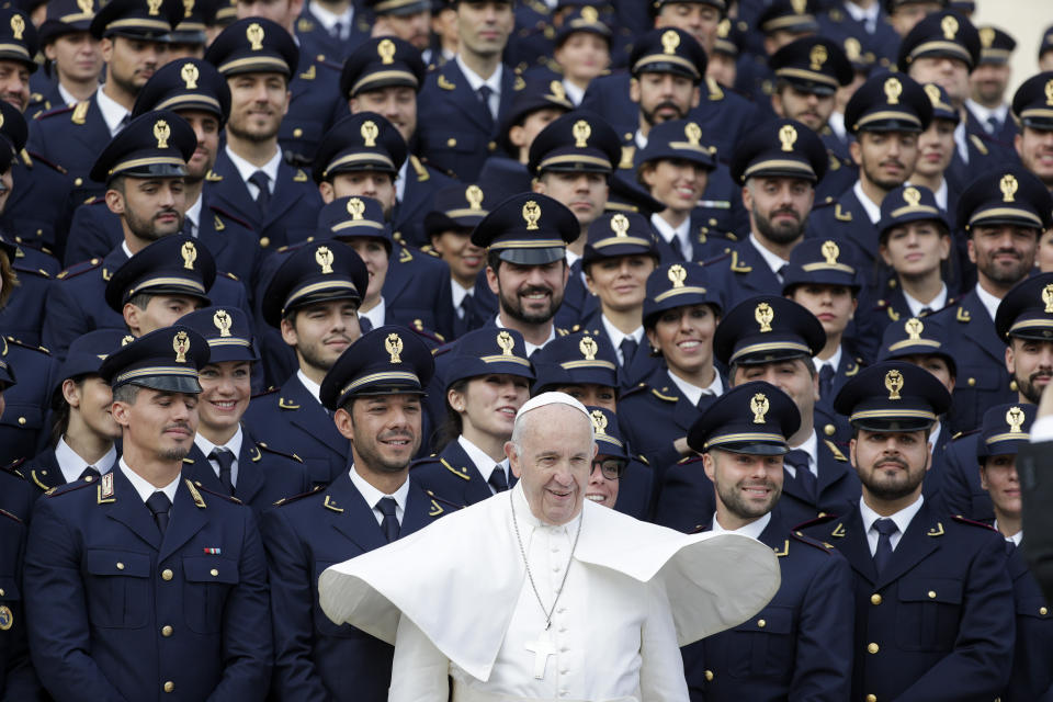 Pope Francis poses with a group of Italian police officers during his weekly general audience, in St. Peter's Square at the Vatican, Wednesday, Nov. 27, 2019. (AP Photo/Andrew Medichini)