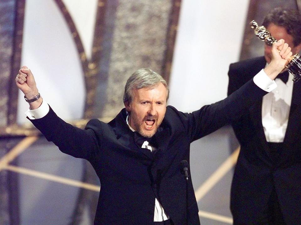 Director James Cameron raises his Oscar after winning in the Best Director Category during the 70th Academy Awards at Shrine Auditorium 23 March. Cameron won for his movie "Titanic."