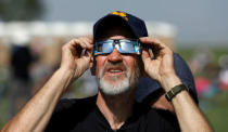 Brian Trybus of Denver, Colo., tries to watch the solar eclipse at Carhenge in Alliance, Neb., U.S. August 21, 2017. Location coordinates for this image are 42°8'33"N 102°51'29"W. REUTERS/Scott Morgan