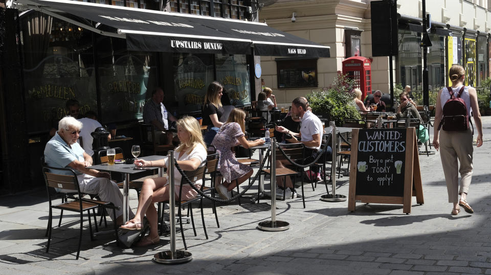 FILE - In this Monday, Aug. 3, 2020 file photo, a sign outside a pub reads: "Wanted Customers" in central London. Early indications suggest that hungry, and often nervous, customers are being enticed back to restaurants in the U.K. as a result of a British government eating out discount scheme between Monday and Wednesday aimed at protecting jobs in the hospitality sector, which was hit badly during the coronavirus lockdown. Figures Tuesday, Aug. 18 from the Treasury show that food outlets have claimed for over 35 million meals discounted meals in the first half August with the number of covers more than tripling in the second week alone.  (AP Photo/Alastair Grant, file)