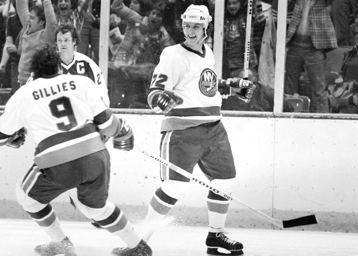 FILE - Mike Bossy, right, of the New York Islanders, reacts after he scored the winning goal in overtime to beat the Toronto Maple Leafs 3-1 at the Nassau Coliseum in Uniondale, N.Y., April 20, 1978. At left are Clark Gillies of the Islanders and the Maple Leafs' captain Darryl Sittler. Bossy, one of hockey’s most prolific goal-scorers and a star for the New York Islanders during their 1980s dynasty, died Thursday, April 14, 2022, after a battle with lung cancer. He was 65. (AP Photo/Ray Stubblebine)