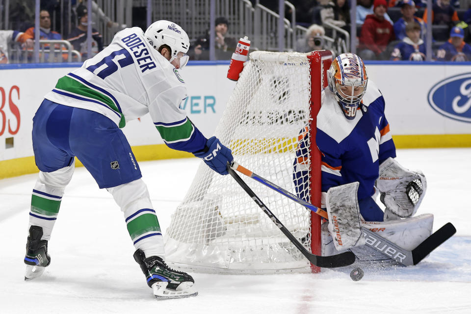 New York Islanders goaltender Ilya Sorokin makes a save on a shot by Vancouver Canucks right wing Brock Boeser (6) in the first period of an NHL hockey game Tuesday, Jan. 9, 2024, in Elmont, N.Y. (AP Photo/Adam Hunger)