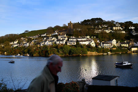 A man walks through Newton Ferrers, Devon, Britain April 11, 2017. REUTERS/Dylan Martinez